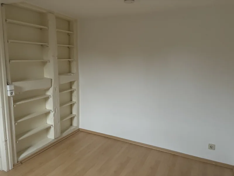 Bedroom with built-in storage shelves