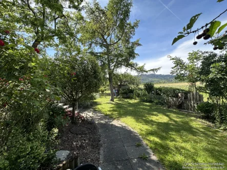 Garten - Wohnung kaufen in Staufen im Breisgau - Charaktervolle Erdgeschosswohnung mit Gartenidylle und außergewöhnlichem Flair