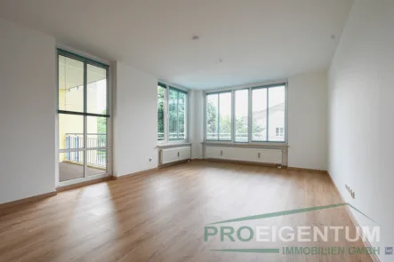 großes Wohnzimmer - Wohnung kaufen in München - ProEigentum: Großzügige 2-Zi-Wohnung mit Südbalkon, EBK, neue Böden, Top-Zustand, sofort verfügbar