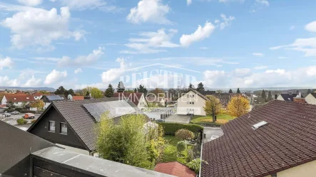 Aussicht - Wohnung kaufen in Haßfurt - Blick über Haßfurt - Gemütliche 3-Zimmer-Dachgeschosswohnung in ruhiger Ortsrandlage