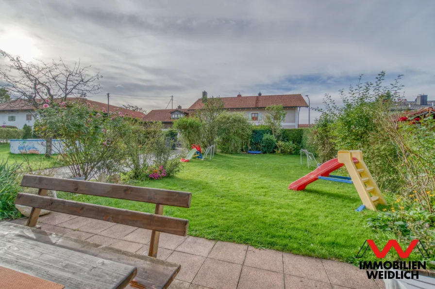 Blick von der sonnigen Terrasse in den Garten