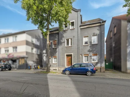 Titelbild - Haus kaufen in Dortmund - Attraktives Mehrfamilienhaus mit Option zum Baugrundstück in Lütgendortmund