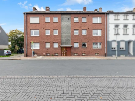 Hausansicht - Wohnung kaufen in Dinslaken - 3-Zimmer-Wohnung mit Balkon, Garage und Stellplatz im 1. Obergeschoss in Dinslaken Feldmark