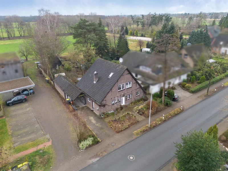 Titelbild - Haus kaufen in Weyhe - Neues Dach März 2025! Saniertes Einfamilienhaus mit traumhaft eingewachsenem Garten in Weyhe Leeste