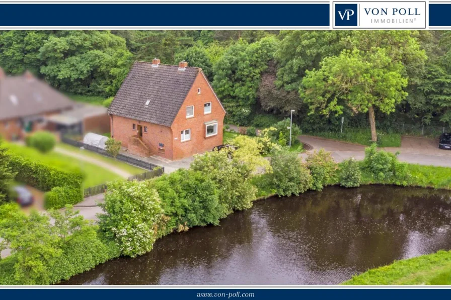 Titel - Haus kaufen in Emden / Wolthusen - Doppeltes Wohnglück: Zweifamilienhaus mit Kanalblick in Emden Wolthusen