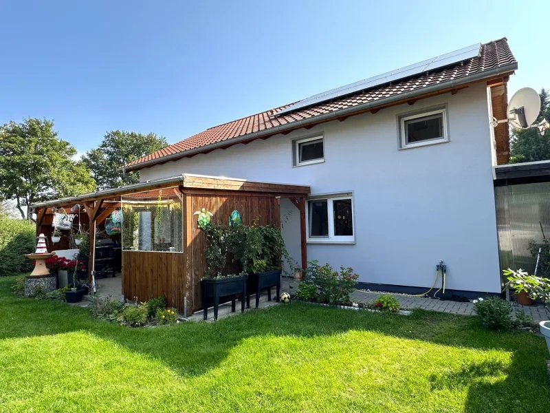 überdachte Terrasse mit Blick in den Garten