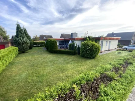 Rückansicht mit Terrasse - Haus kaufen in Wittmund - Bungalow in guter Wohnlage - Verkauf am 18.10.2024