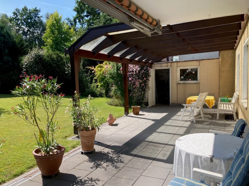 Überdachte Terrasse mit Blick in den gepflegten Garten