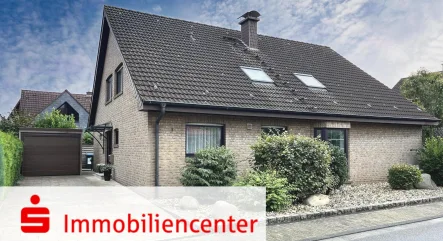 Die Straßenansicht  - Haus kaufen in Marl - Freistehendes und top gepflegtes Zweifamilienhaus mit Garage auf schönem Kaufgrundstück in Zentrumsnähe