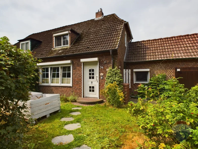 Frontansicht - Haus kaufen in Brunsbüttel - Attraktive Doppelhaushälfte mit großzügigem Wintergarten und Garten mit besonderer Atmosphäre