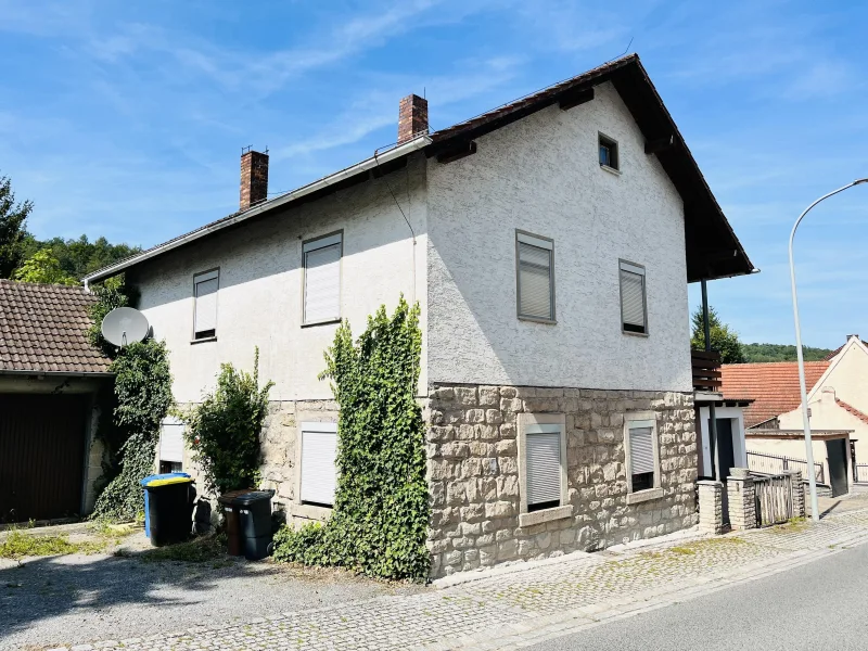 Südwestansicht des Hauses (Straßenseite) - Haus kaufen in Oberaurach - 1.480m² großes Grundstück am grünen Ortsrand... viel Platz bietendes Einfam.-Wohnaus mit Doppelgarage, Wohnfl. 160m² 