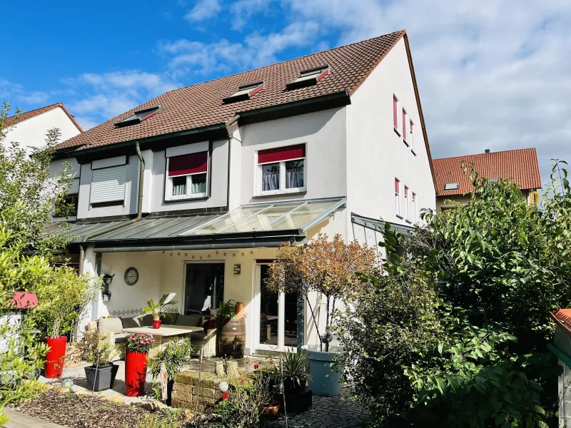 Südwestansicht des Hauses (Gartenseite) - Haus kaufen in Haßfurt - Familienparadies im Grünen: gepflegte Doppelhaushälfte mit viel Platz und Extras, sonniger Garten/Terrasse, Garage 