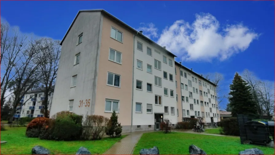 Gebäudeansicht - Wohnung kaufen in Langen - Modernisierte EG-Wohnung mit Loggia & Blick ins Grüne 