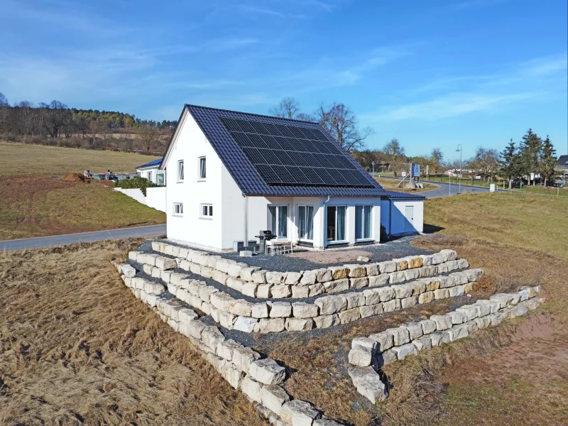 Haus- und Gartenansicht - Haus kaufen in Geisa - Neubau-Idylle trifft malerische Landschaft: Modernes Einfamilienhaus mit märchenhaftem Ausblick