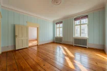 Living room with floorboards and wall paintings