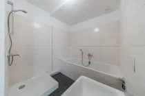 Bathroom with bathtub and shower