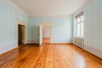 Living room with floorboards and murals