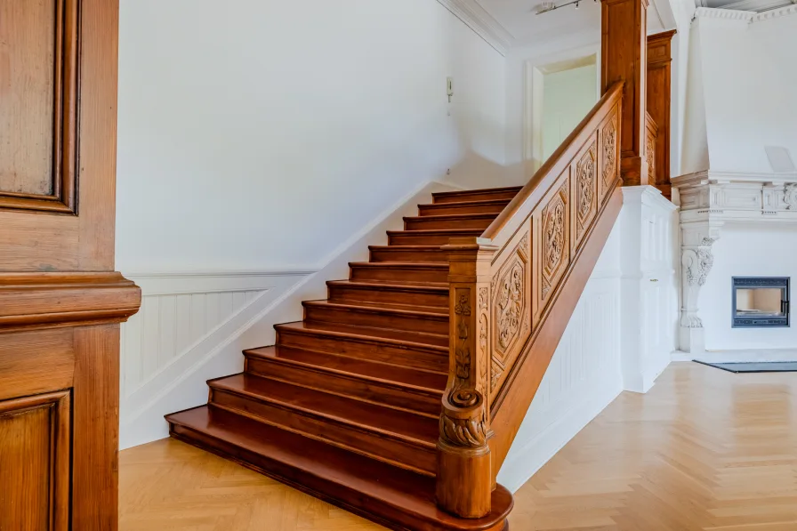 Open wooden staircase with unique carvings 