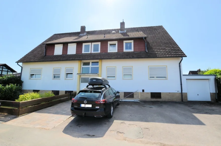 Eigentumswohnung mit Gartenanteil Balkon und Garage - Heise Immobilien