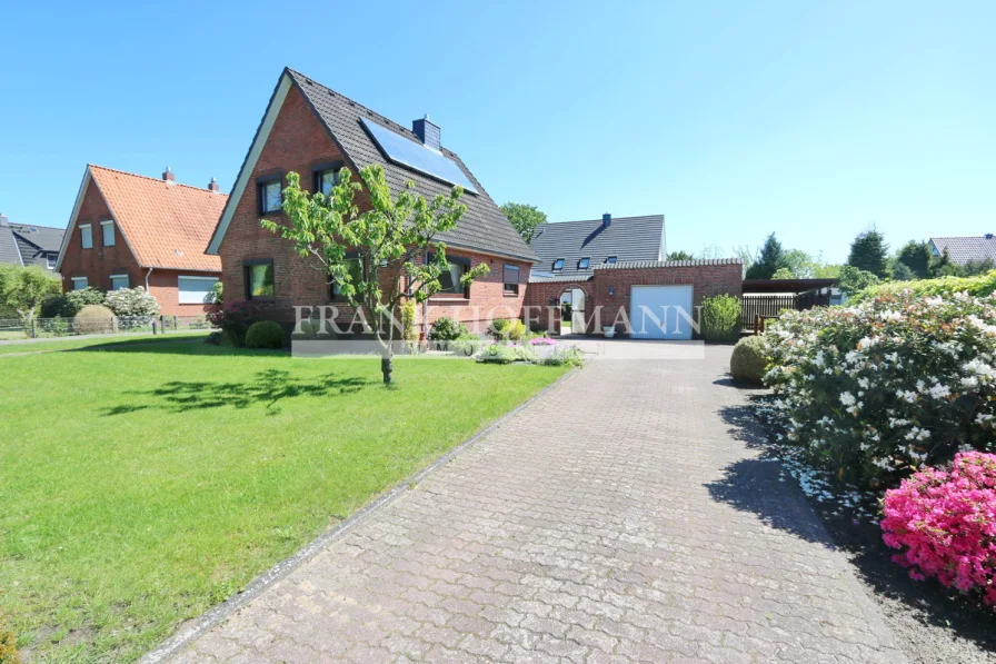 Hausansicht front - Haus kaufen in Hasloh - Gepflegtes Einfamilienhaus mit Vollkeller & Garage auf großzügigem Grundstück in Hasloh