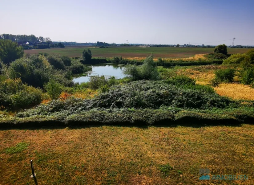 Weiter Blick in die Landschaft mit Teich