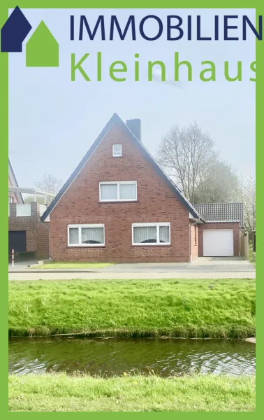Straßenansicht - Haus kaufen in Papenburg - Ansprechendes Einfamilienhaus mit großer gemauerter Partyhütte und Garage an Kanallage zu Kaufen!