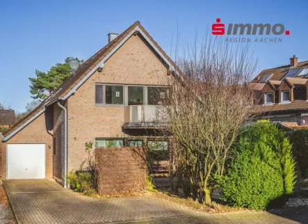 Straßenansicht mit Logo - Haus kaufen in Aachen - Freistehendes Zweifamilienhaus mit Garage in ruhiger Spielstraße