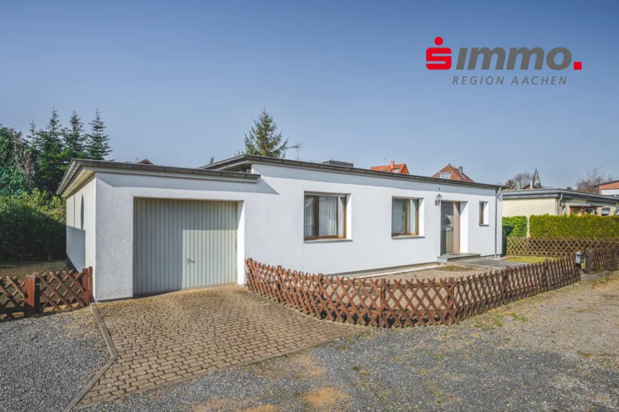 Front 1 mit Logo - Haus kaufen in Eschweiler - Frei stehender Bungalow mit außergewöhnlich großem Garten und Garage in einer Privatstraße