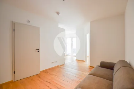 Wohnbereich (1) - Wohnung mieten in Föhren - Teilmöbliertes Neubau-Appartement als Singlewohnung // 2 Zimmer, Balkon, Küche, Aufzug, Tiefgarage, Stellplatz // ab sofort