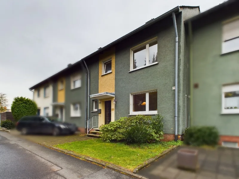 Schrägansicht - Haus kaufen in Hamm - Familienfreundliches Reihenmittelhaus mit Keller und Garage in Hamm-Westen