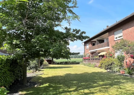 Gartenansicht - Wohnung kaufen in Wesel - Gepflegte 4-Zimmerwohnung mit Balkon am Ortsrand von Wesel-Flüren