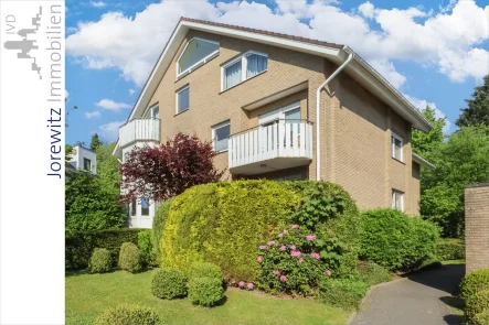 001 - Seitenansicht - Wohnung kaufen in Bielefeld - Hoberge-Uerentrup: Schicke 3,5 Zimmer-Wohnung mit 2 Balkonen, Kamin, EBK, Garage, Tiefgarage und Stellplatz