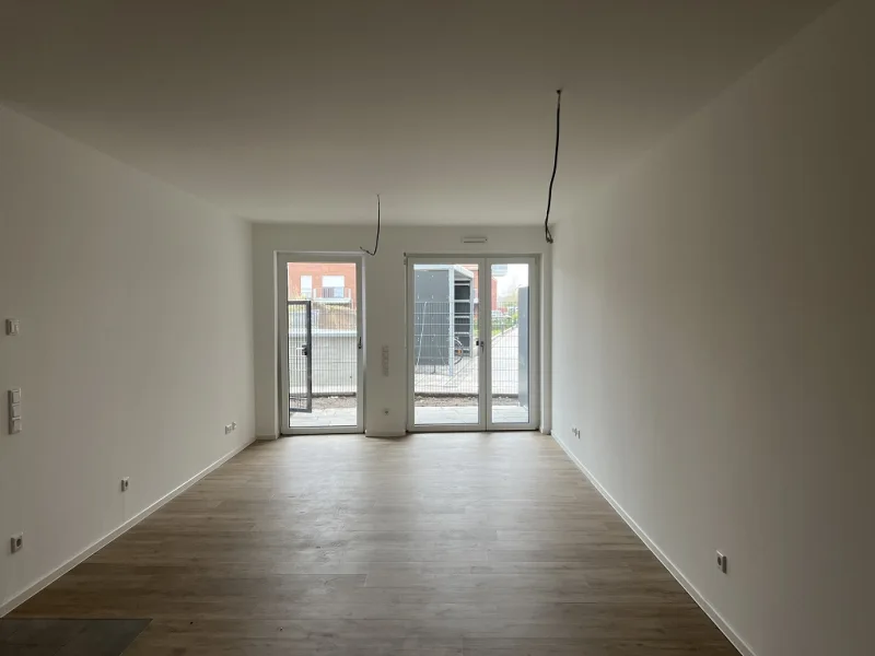 Wohnzimmer - Wohnung kaufen in Telgte - Moderne Neubau-ETW mit Terrasse und TG-Stellplatz: Wohnen auf höchstem Niveau!