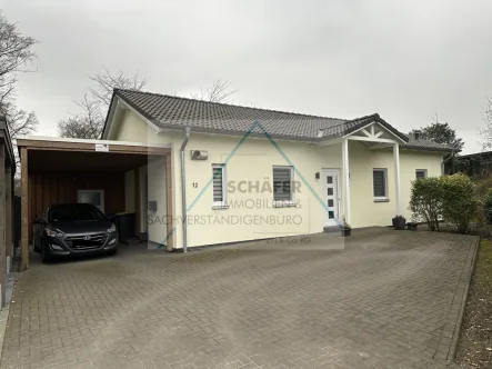 Außenansicht  - Haus kaufen in Bassum - Attraktiver Bungalow, energiesparend durch erneuerbare Energietechnik