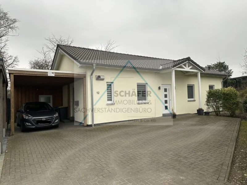 Außenansicht  - Haus kaufen in Bassum - Attraktiver Bungalow, energiesparend durch erneuerbare Energietechnik