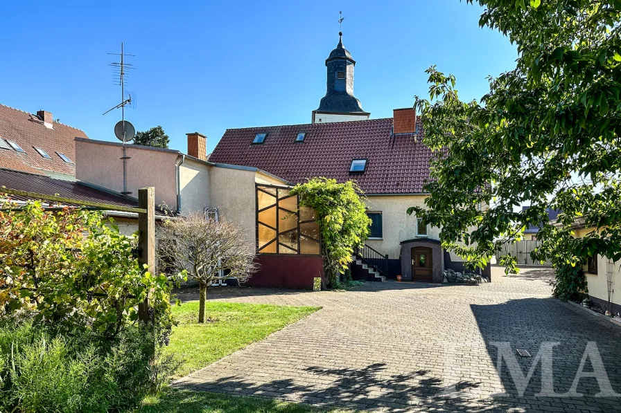 Sommeraufnahme Blick vom Innenhof zum Haus