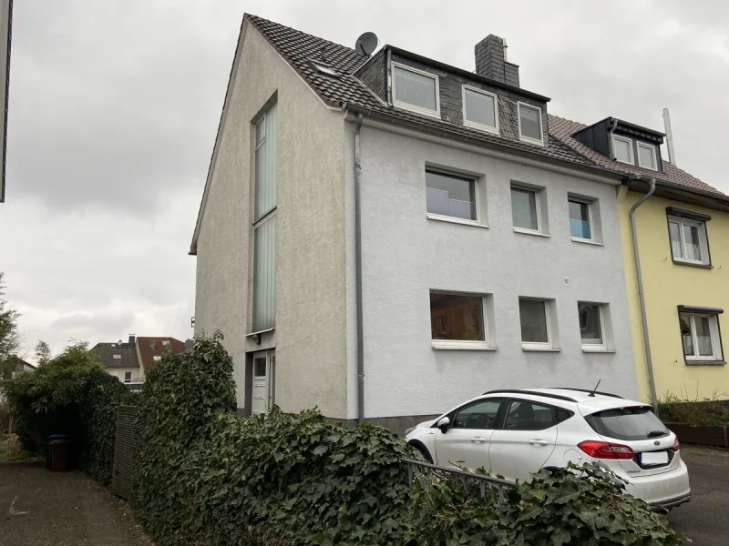 Seitenansicht - Zinshaus/Renditeobjekt kaufen in Bergisch Gladbach - Bergisch Gladbach-Hand: Mehrfamilienhaus mit vier Wohneinheiten und Garagenhof