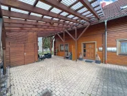 Eingangsbereich mit überdachter Sitzecke und Carport