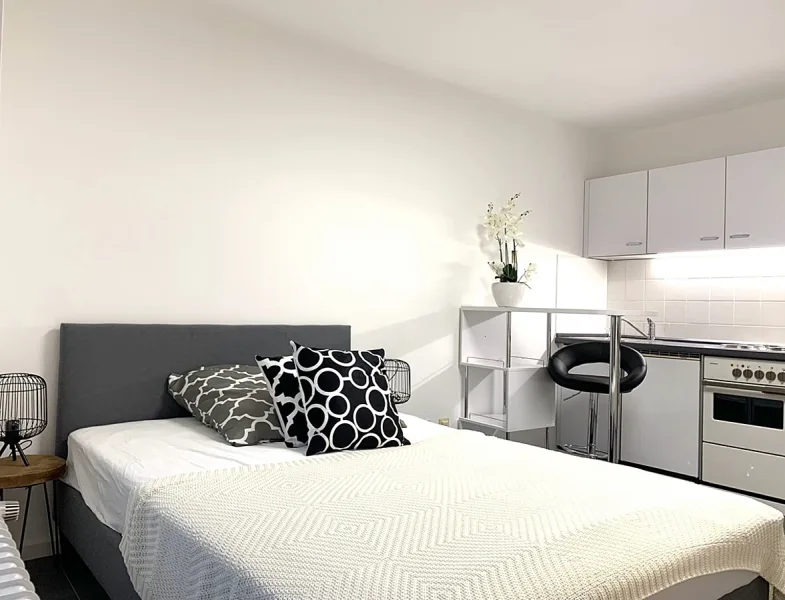 Der Schlafbereich - Wohnung kaufen in München - Interessantes Investment: vermietetes Appartement mit zusätzlichen Einnahmen durch Hotel/Restaurant